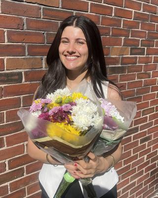 Victoria holding flowers